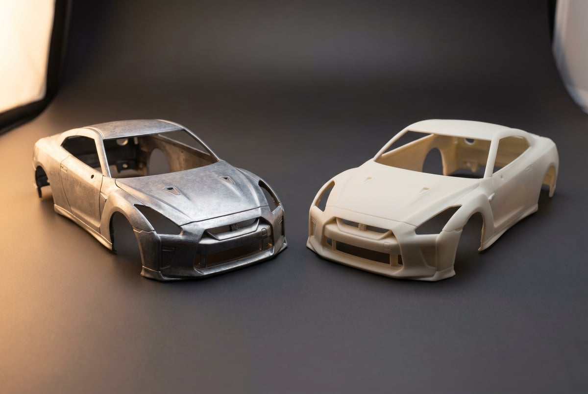 Close-up comparison of a zamak diecast body shell and a polyurethane resin body shell